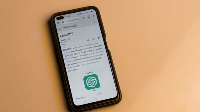 A smartphone displaying the Wikipedia page for ChatGPT, illustrating its technology interface.