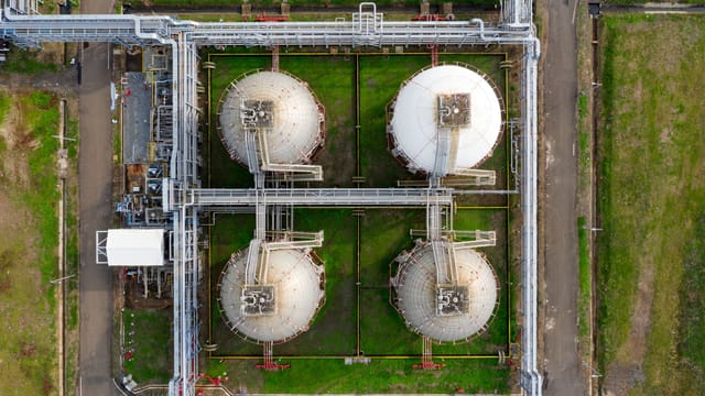 Aerial view of large industrial storage tanks in Banten, Indonesia, showcasing infrastructure and industry.