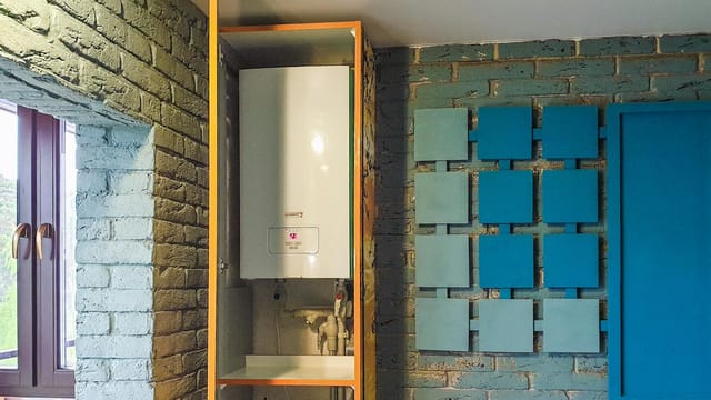 Indoor view of a water heater neatly installed in a cabinet with modern decor.