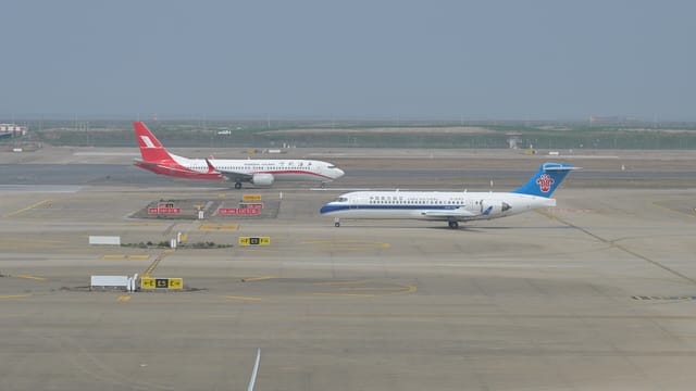 Shanghai Airlines Boeing 737-8 MAX and China Southern Comac C909 at Shanghai Pudong June 2025