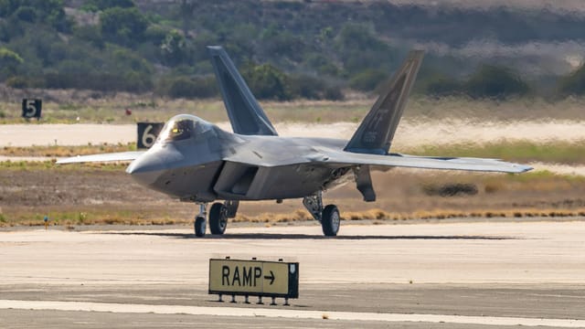 An F-22 Raptor jet fighter stationed on a runway during the Miramar Airshow in San Diego.