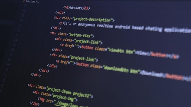 Close-up of HTML code with syntax highlighting on a computer monitor.