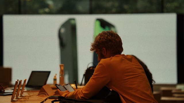 A customer examines smartphones in a modern İstanbul gadget store.