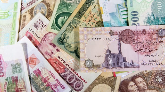 A vibrant collection of various international banknotes showcasing global diversity.