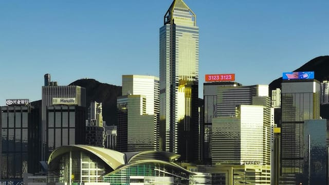 Stunning view of Hong Kong skyline with modern architecture and waterfront reflections at twilight.