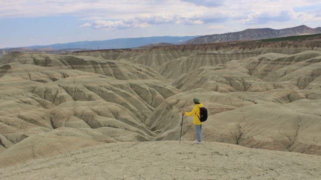 A hiker explores the unique geological formations and undulating hills of Nallıhan, Ankara, Türkiye.