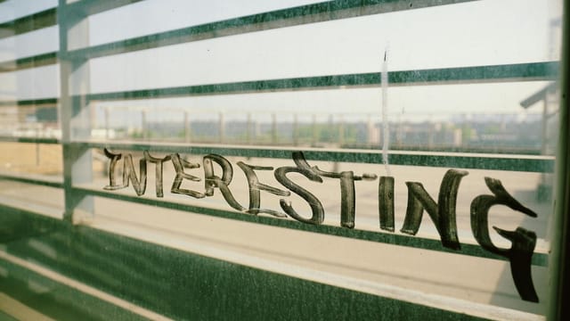 Urban graffiti on a window overlooking Xi An cityscape, capturing gritty textures and urban vibe.
