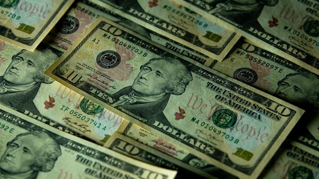 A detailed view of multiple ten dollar bills showcasing American currency and financial concepts.