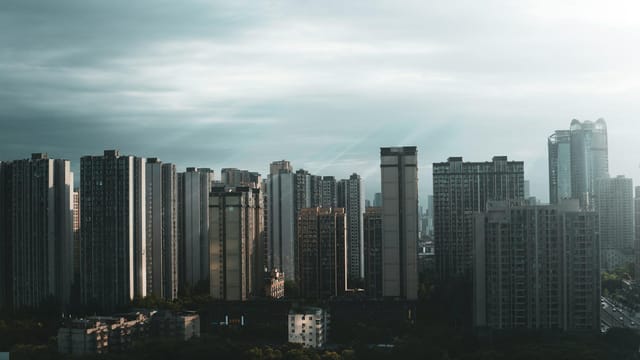 Discover the stunning skyline of Chengdu, Sichuan, with towering modern skyscrapers beneath an overcast sky.