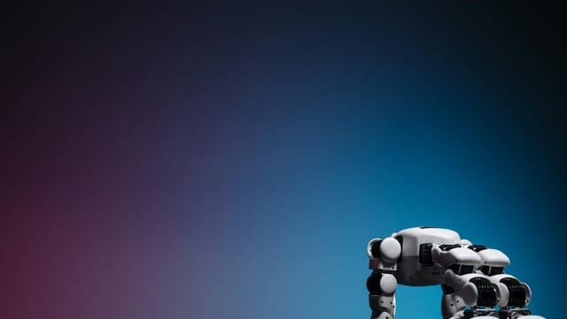 A close-up of a futuristic robot toy on a reflective surface against a gradient background.