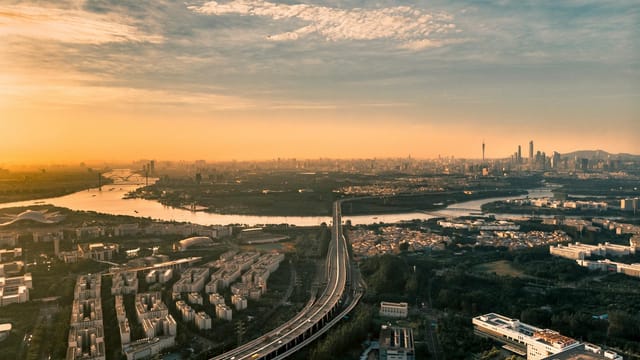 Stunning aerial shot of Guangzhou skyline and Pearl River at sunrise, capturing the urban landscape and architecture.