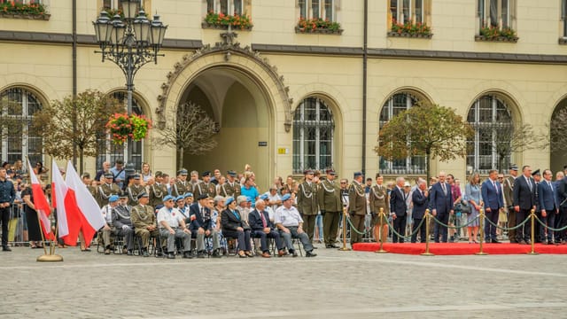 Polish military ceremony in Wrocław with flags and uniformed personnel.