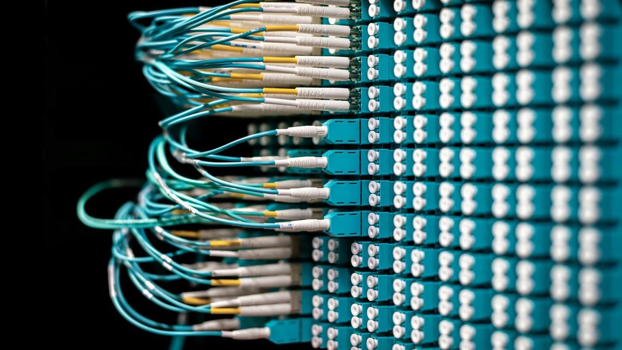 Server with electronic switches and connectors with yellow and green wires plugged in plastic device in operating room on black background