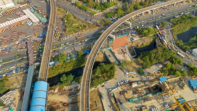 Drone shot of busy urban area with roads, construction, and transportation