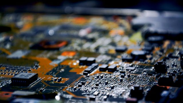 Detailed close-up view of electronic circuit board, showcasing modern technology.