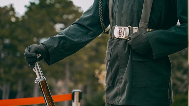 Detailed view of a Turkish soldier in uniform holding a rifle, outdoors in Ankara.