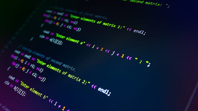 Close-up of colorful programming code displayed on a monitor screen.