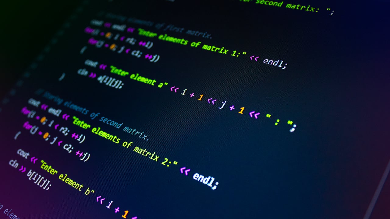 Close-up of colorful programming code displayed on a monitor screen.