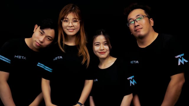 Four diverse young adults in META logo T-shirts against a black background.