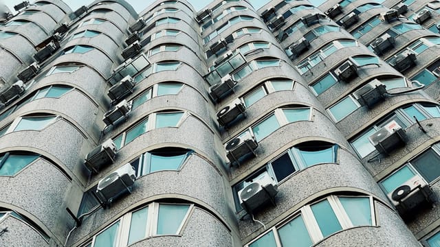 Low angle view of a modern apartment building facade in Beijing, showcasing its unique architecture.