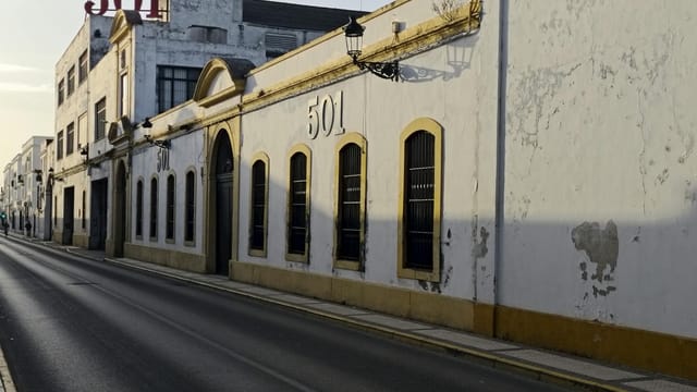 Historic streetscape of El Puerto de Santa María, showcasing classic Andalusian architecture.