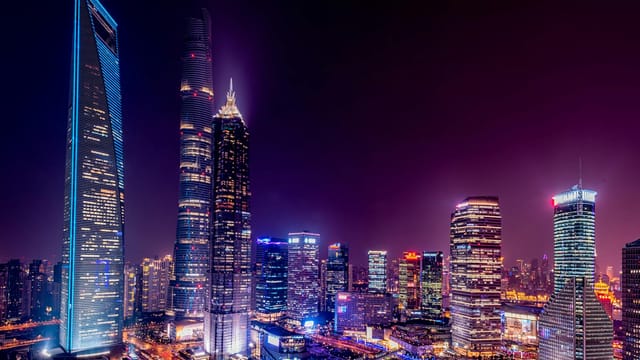 Majestic view of Shanghai's illuminated skyline featuring iconic skyscrapers at night.