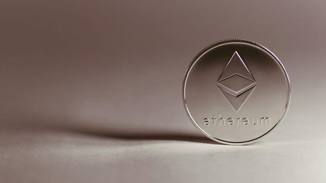 Close-up of a silver Ethereum coin symbolizing digital currency and blockchain technology.