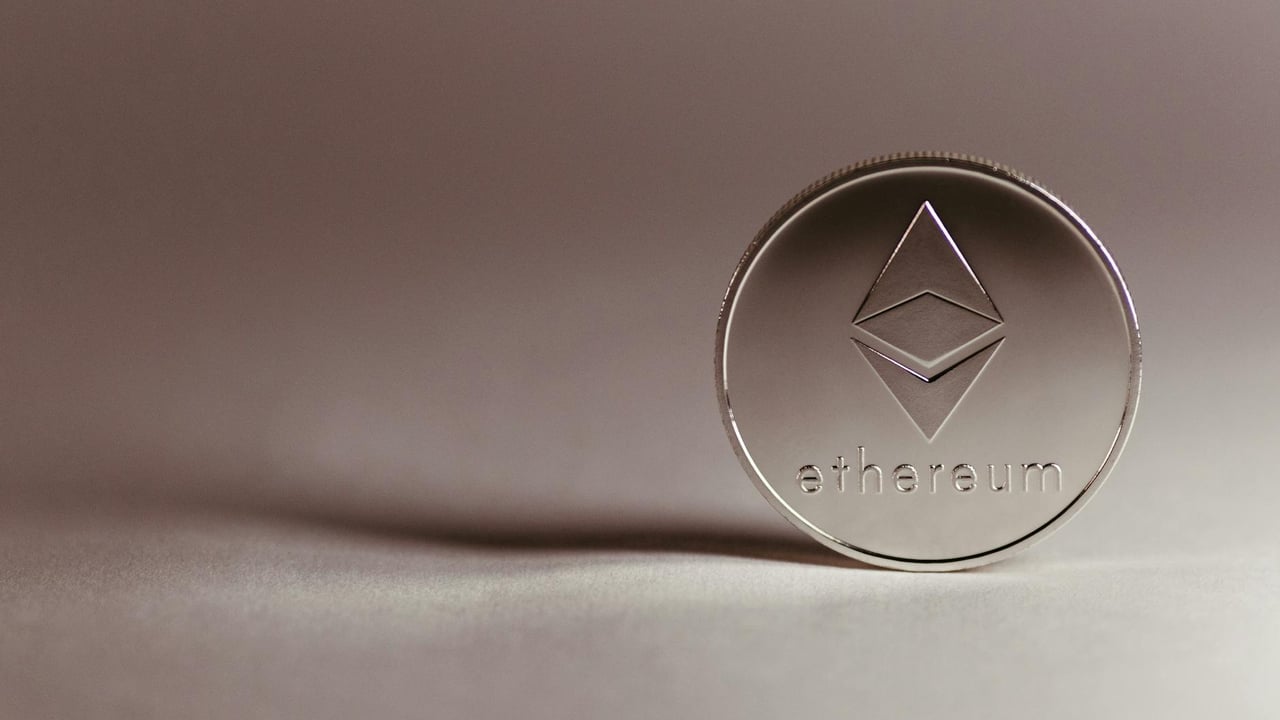 Close-up of a silver Ethereum coin symbolizing digital currency and blockchain technology.