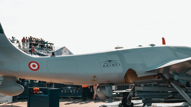 Bayraktar Akinci drone displayed at a busy airshow with spectators.