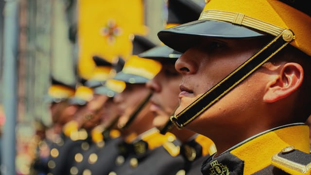 A close-up of uniformed guards in formation during a military parade, showcasing their discipline and coordination.