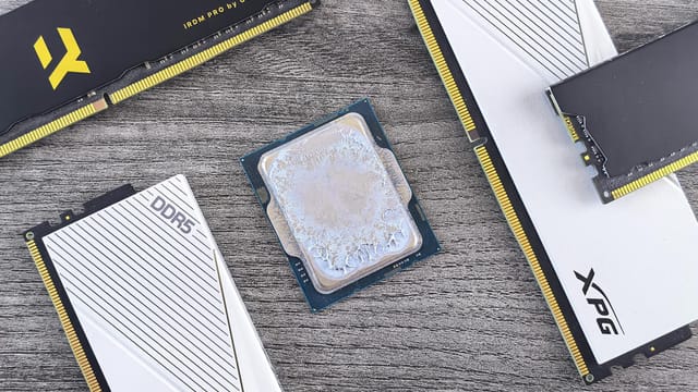 Detailed shot of DDR5 RAM modules and a CPU on a wooden table, highlighting computer hardware.