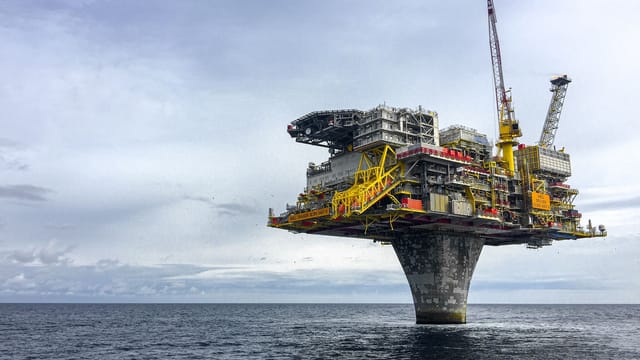 Dramatic view of a large oil platform in Norway's North Sea, symbolizing offshore industry.