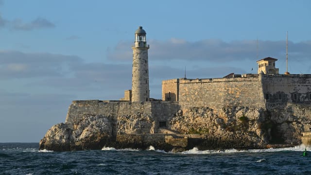 El Morro Lighthouse stands proudly over the waters of Havana Bay in Cuba, showcasing historical architecture.