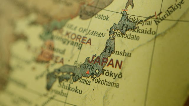 Close-up of a vintage map highlighting Japan and Korea with a selective focus.