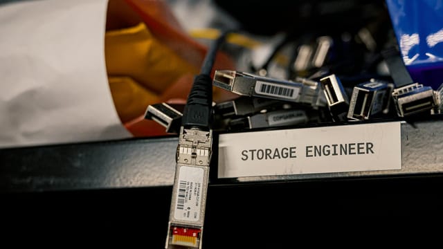 Low angle of various connectors and USB cables placed on shelf with storage engineer inscription