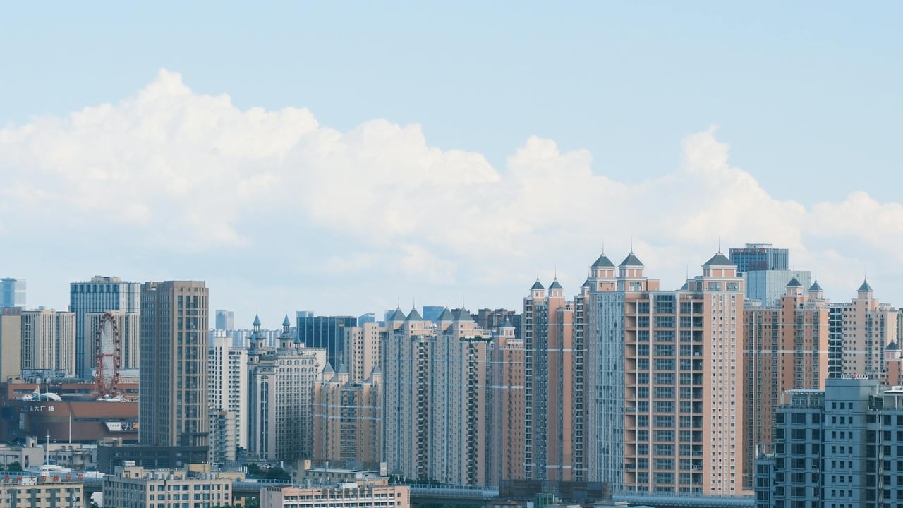 A vibrant city skyline with modern skyscrapers under a clear blue sky.