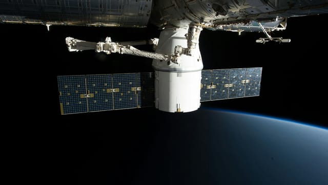 A SpaceX satellite hovering over Earth's horizon in outer space, showcasing advanced space technology.
