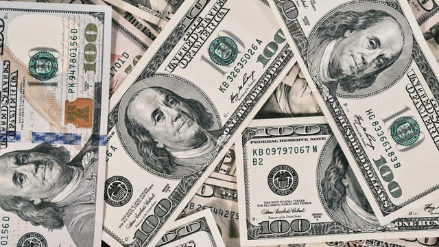 Detailed close-up of US dollar bills highlighting wealth and finance concepts.