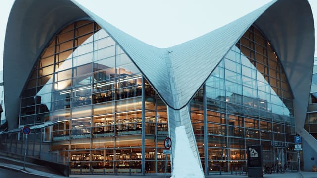 Contemporary design of Tromsø library with unique roof structure in Norway.