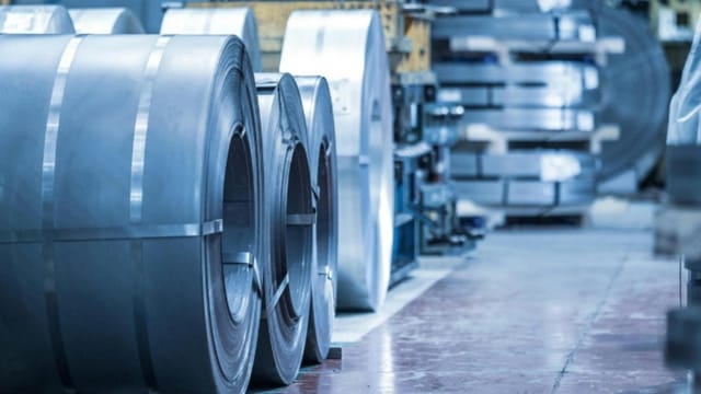 Close-up of coiled metal sheets in an industrial factory. Precision engineering materials.