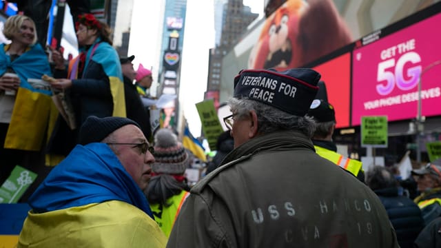 Protesters in Times Square, New York, advocating peace and supporting Ukraine.