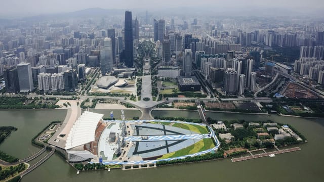 Aerial view of Guangzhou cityscape with towering skyscrapers and urban landscape.