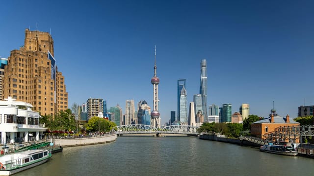 Stunning view of Shanghai's skyline featuring the iconic Oriental Pearl Tower against a clear blue sky.