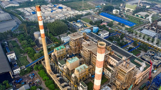 Bird's-eye view of a sprawling industrial plant in Serang, showcasing smokestacks and facilities.