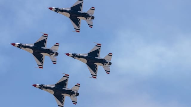 F-16 Thunderbirds performing aerial maneuvers at an air show in Wantagh, NY.
