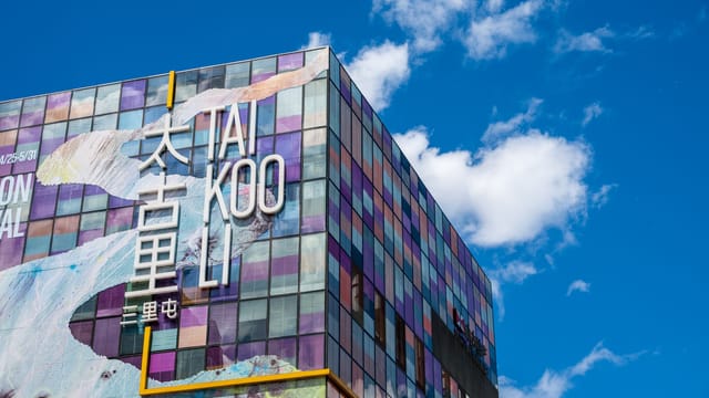 Colorful facade of Taikoo Li shopping center against a blue sky in Beijing, China.