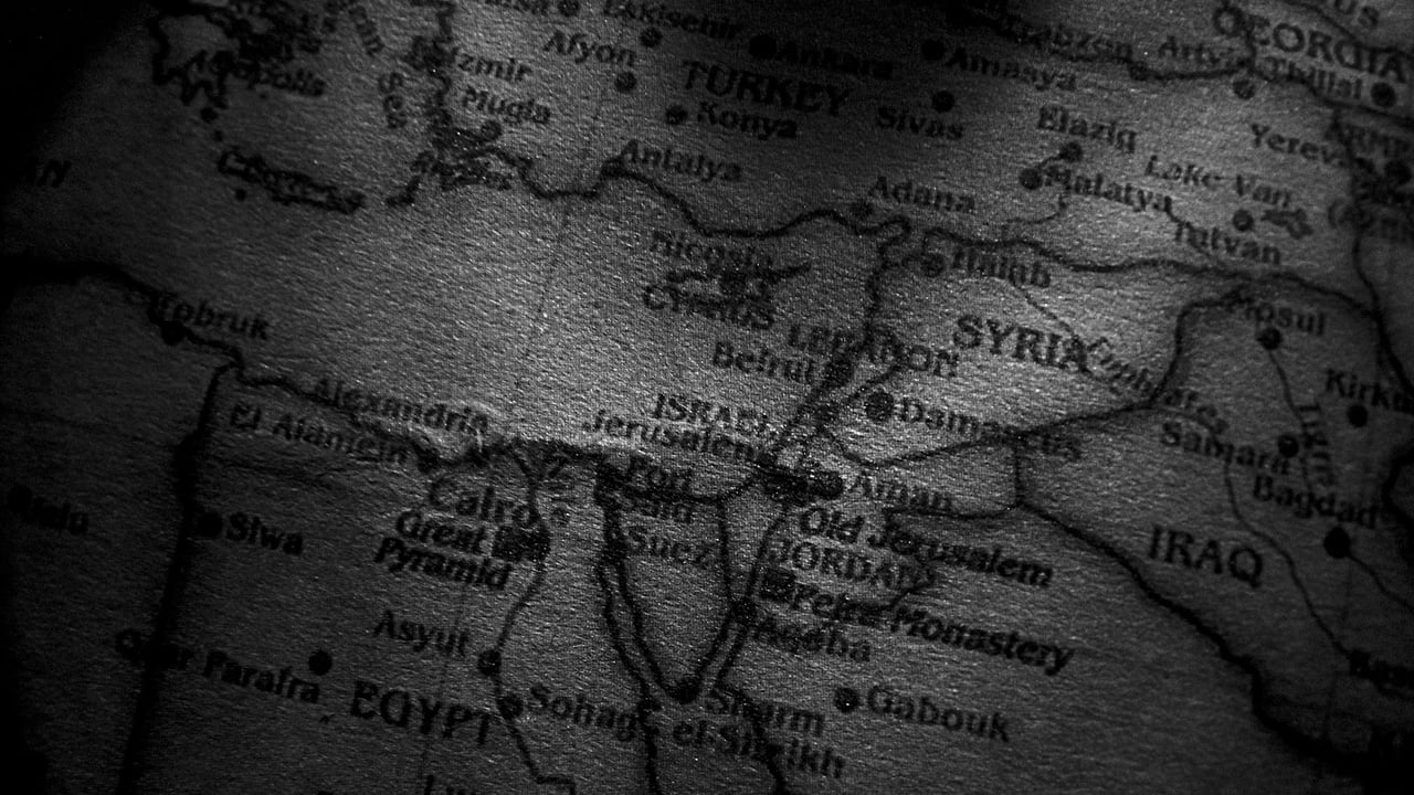 Close-up grayscale image of a map showing countries in the Middle East, including Egypt, Syria, and Iraq.