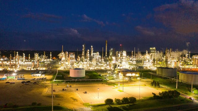 A stunning aerial shot of an illuminated oil refinery at night showcasing industrial production in Rosemount, MN.