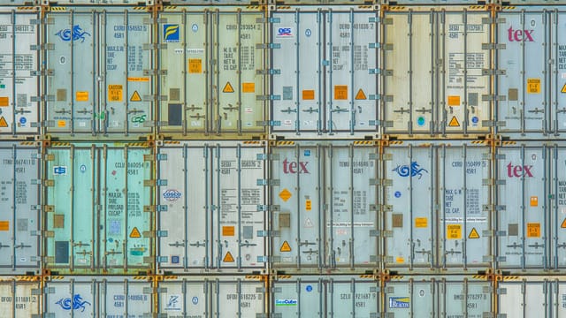 Illustrative image: A vibrant display of stacked shipping containers, highlighting industrial organization.