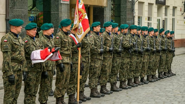 Polish soldiers in uniform during a ceremonial formation in Wrocław, Poland.